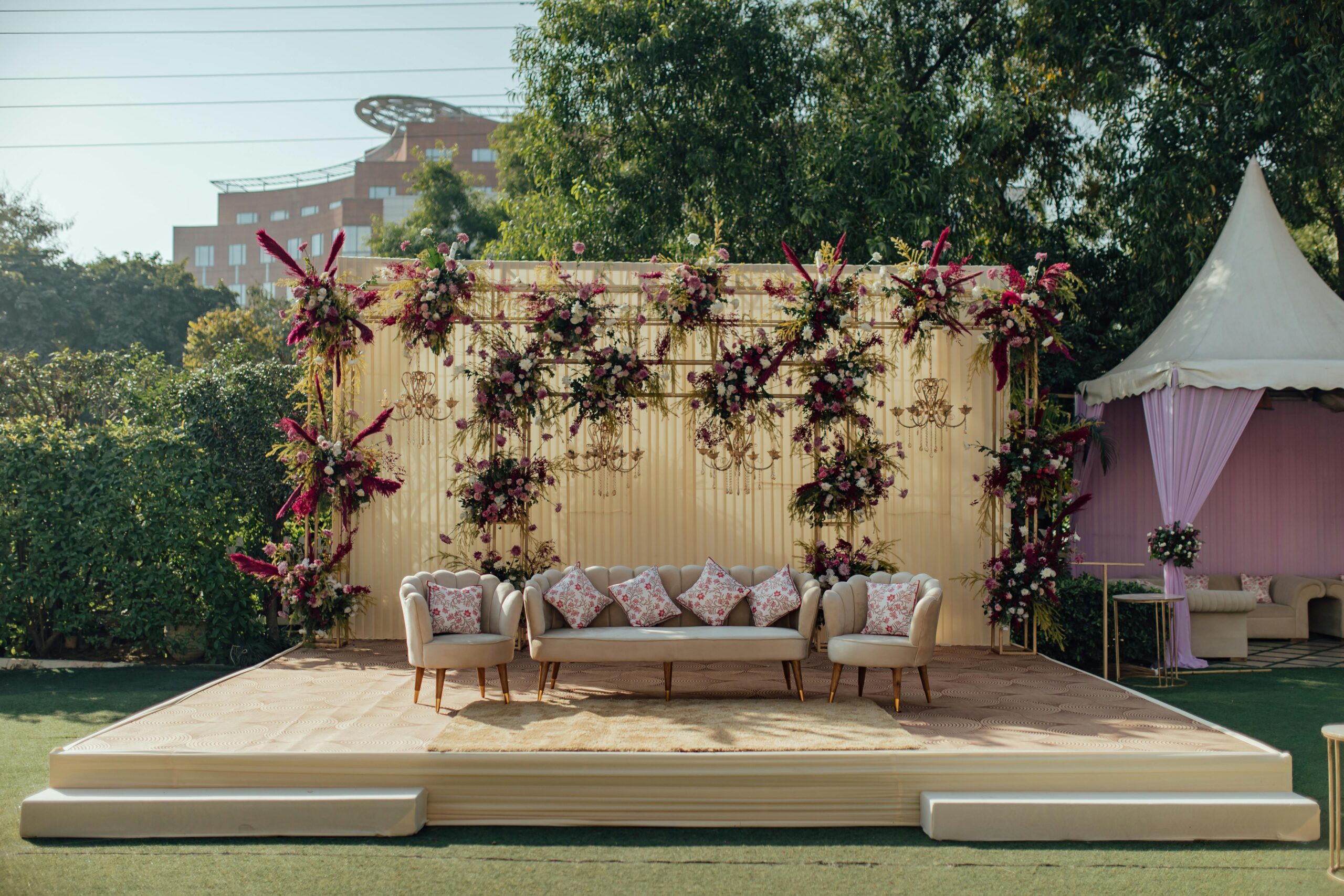 Beautifully decorated outdoor wedding seating area with lush floral arrangements and elegant furniture.